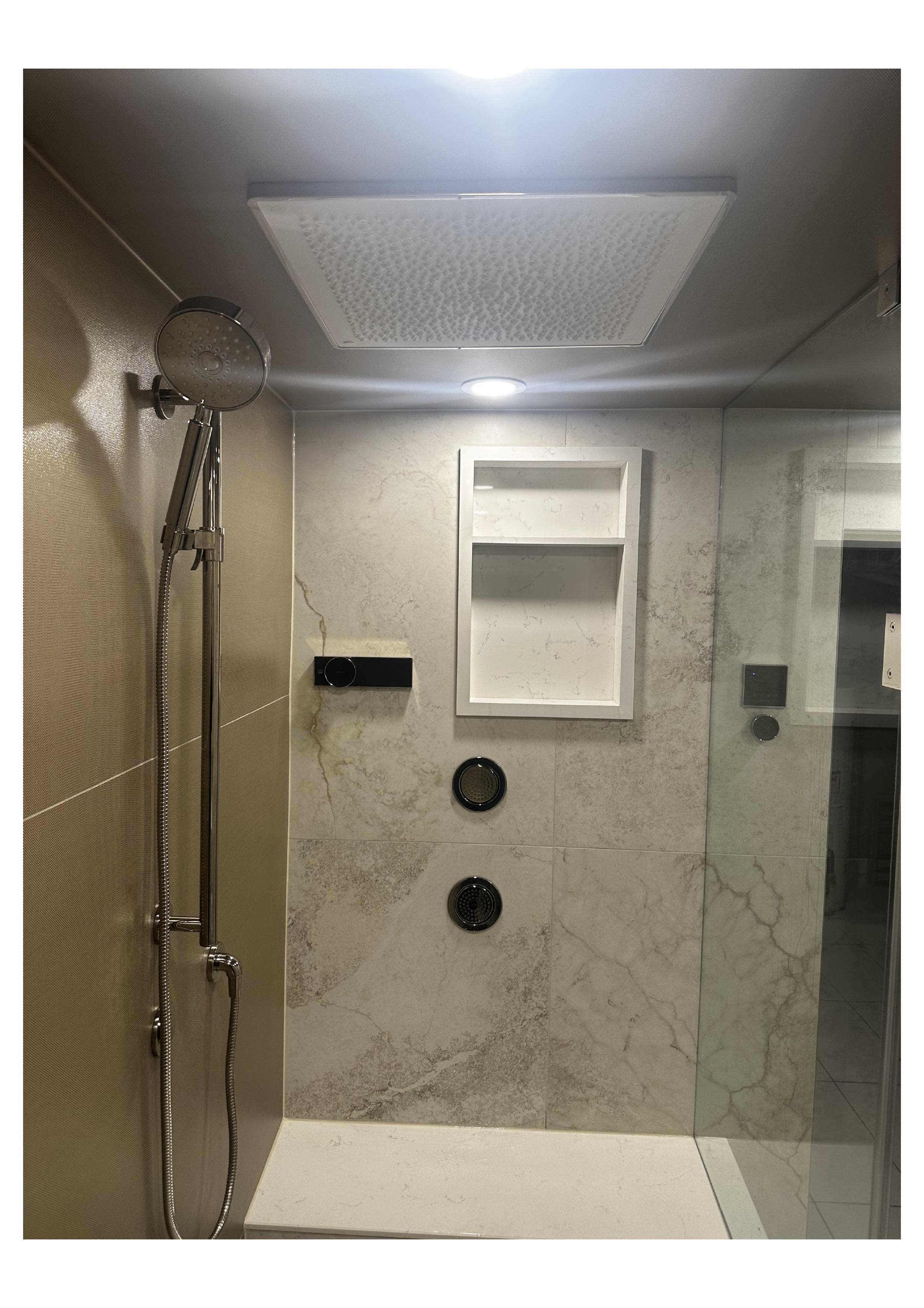 Marble shower with dual shower heads installed by Everline Plumbing